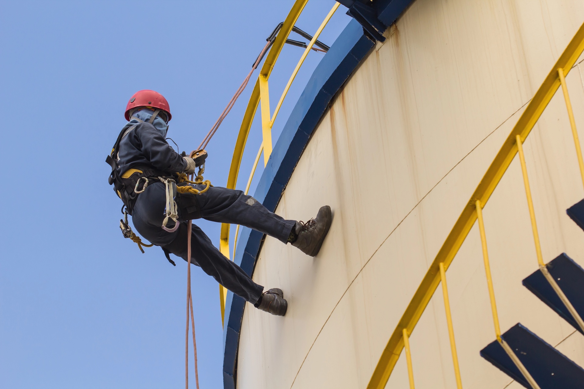 Male worker rope access inspection tank oil